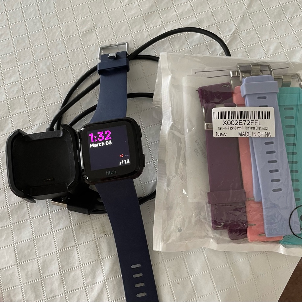 Fitbit Versa, excellent condition.  Comes with charger and 4 extra wristbands.